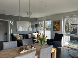 a living room with a dining table and a couch at Hering in Scharbeutz