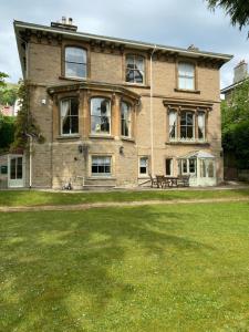a large brick house with a bench in front of it at Garden View in Great Malvern