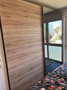 a wooden door in a bedroom with a mirror at Hering in Scharbeutz