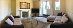 a living room with two couches and a fireplace at Garden View in Great Malvern +15 photos