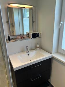 a bathroom with a sink and a mirror at Hering in Scharbeutz +13 photos