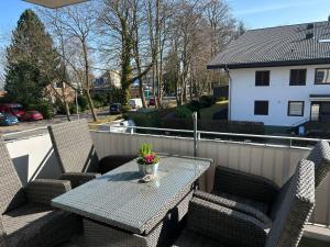 a patio table and chairs on a balcony at Hering in Scharbeutz