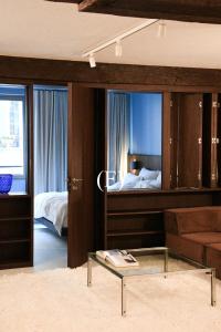 a living room with a bed and a glass table at Suite d'exception Marais in Paris