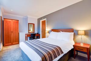 a bedroom with a large bed and a desk at Aston Court Derby City Centre by Belvilla in Derby
