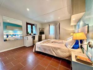 a bedroom with a large bed in a room at Camping Village Tuscia Tirrenica in Tarquinia