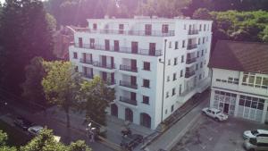 a white building with cars parked in front of it at "Moon M" Lux Studio - Free Parking in Vrnjačka Banja