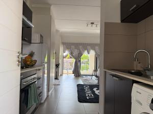 a kitchen with a sink and a counter top at Dainfern Cozy Condo in Midrand