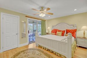 a bedroom with a white bed and a ceiling fan at Mariners Walk 4C by Wild Dunes, Ocean View Condo in Isle of Palms