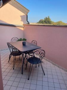 a table and chairs sitting on a patio at La Mansardina in Palmanova +2 photos
