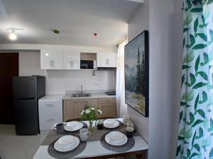 a kitchen with a table with plates on it at Harmony Condo 620 in Mandaue City