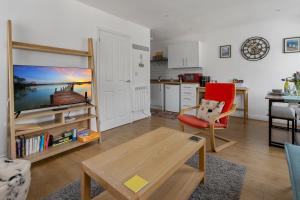 ブリクサムにあるOur Happy Place- With Parking & Upgraded WiFi for 2025のリビングルーム(赤い椅子、テーブル付)