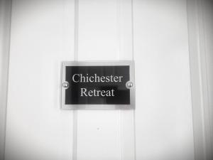 a sign on a door that reads chiologist retreat at Chichester Retreat City Centre Flat I Peaceful Location & Great Views - Chichester Holiday Properties in Chichester