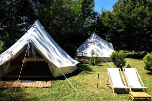 a tent and two chairs in a field at Camping de Salviac in Salviac +11 photos