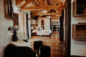 a living room with a couch and a bed at Châteaux dans les Arbres in Clottes