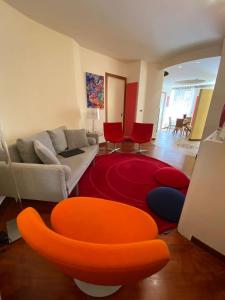 a living room with a couch and a red rug at Jolie maison in Montalbano Jonico
