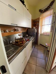 a kitchen with a sink and a stove top oven at Jolie maison in Montalbano Jonico