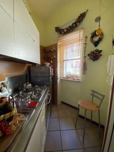 a kitchen with a stove and a counter top at Jolie maison in Montalbano Jonico +4 photos