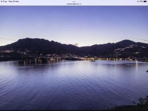 a view of a large body of water with mountains at Astrio Suites in Livadi