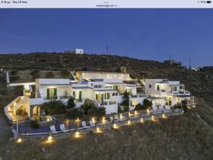 a large white building with lights in front of it at Astrio Suites in Livadi