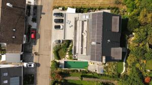 an overhead view of a large building with cars parked at Bodensee-Apartment SeeZeichen No 26 in Bodman-Ludwigshafen