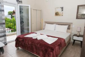 a bedroom with a bed with towels on it at Ύδνα studios in Pefki