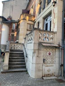 a building with a set of stairs in front of it at Studio proche gare centre ville au calme côté cour in Orléans