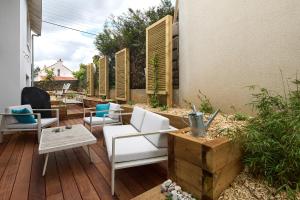 a patio with white chairs and a table at Le Loft Nantais - Superbe Loft de 300m² in Nantes