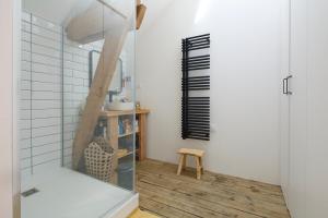 a room with white walls and a glass partition with a stool at Le Loft Nantais - Superbe Loft de 300m² in Nantes +28 photos