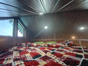 a bed in a room in a boat at Bluepine Cottages Pangot in Nainital +11 photos