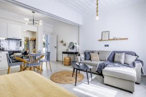 a living room with a couch and a table at VRACHOS HOUSE "In the heart of Skopelos Town" in Skopelos Town