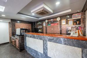 a bar in a restaurant with a counter and a microwave at OYO 825 Hotel Baikuntha in Kathmandu