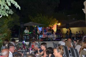 a group of people sitting at a table at a concert at Camping maeva Escapades Parc Valrose in La Londe-les-Maures
