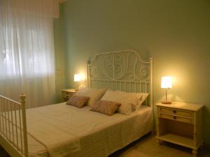 a bedroom with a bed with two night stands and two lamps at Villa Serena in Viareggio