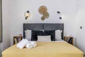 a bedroom with a large bed with towels on it at VRACHOS HOUSE "In the heart of Skopelos Town" in Skopelos Town