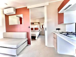 a small room with a kitchen and a bedroom at Camping Village Tuscia Tirrenica in Tarquinia