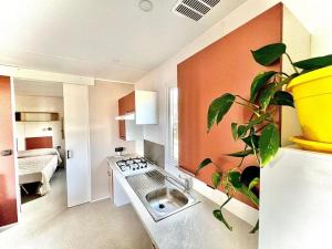 a kitchen with a sink in a room at Camping Village Tuscia Tirrenica in Tarquinia