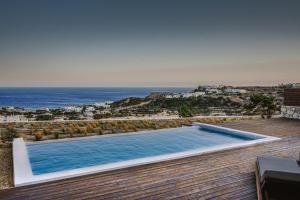 a swimming pool with a view of the ocean at Ammoo in Amoopi