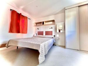 a bedroom with a large bed in a room at Camping Village Tuscia Tirrenica in Tarquinia