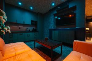 a living room with a couch and a coffee table at Studio Love Ełk explozja zmysłów in Ełk