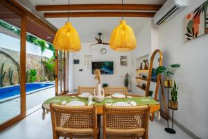 a dining room with a table and chairs at Zahra Villas in Nusa Dua