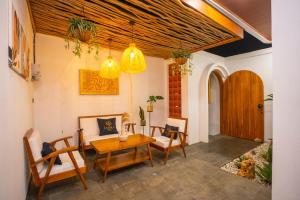 a living room with a wooden table and chairs at Zahra Villas in Nusa Dua