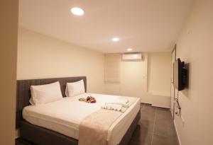 a bedroom with a large white bed in a room at Pekin Spa and Suites in Istanbul