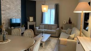 a living room with a couch and a table at NUANCES Gîte Simplicity and elegance 8-pers in Épernay