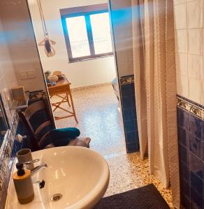 a bathroom with a sink and a chair and a shower at Boutique B&B CASAITANA adults only in Sella +74 photos