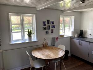 a kitchen with a table and chairs in a room at Cozy holiday home in Dalby