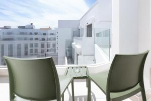 two chairs and a table in front of a window at Modern & bright studio Balcony & Parking Maarif in Casablanca