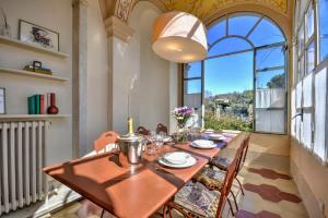 a dining room with a table and a large window at La Prima Torre Charme - Garden and shared Pool in San Lorenzo della Costa