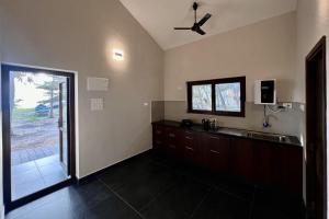 a bathroom with a sink and a ceiling fan at Beach Heaven in Udupi
