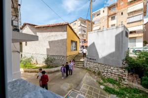 a group of children walking down a street at Huna Apartment in Sarandë