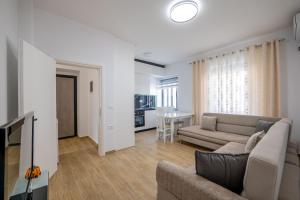 a living room with a couch and a table at Huna Apartment in Sarandë